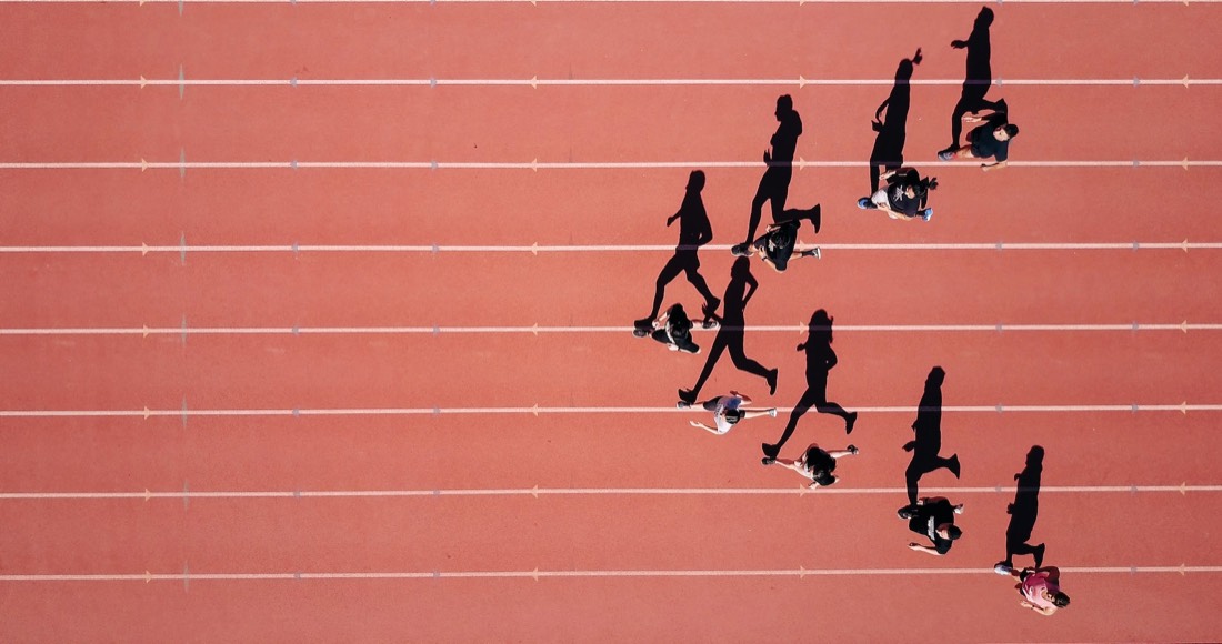 Athletes running on track β sports excellence in action