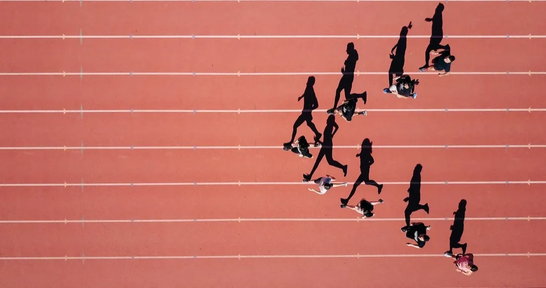 Athletes running on track β sports excellence in action
